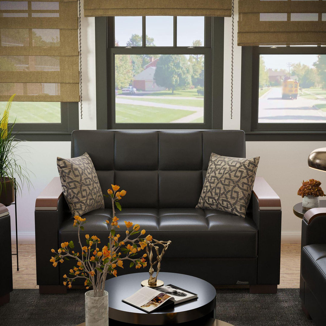Modern design, Black , Artificial Leather upholstered convertible sleeper Loveseat with underseat storage from Voyage Luxe by Ottomanson in living room lifestyle setting by itself. This Loveseat measures 67 inches width by 36 inches depth by 41 inches height.